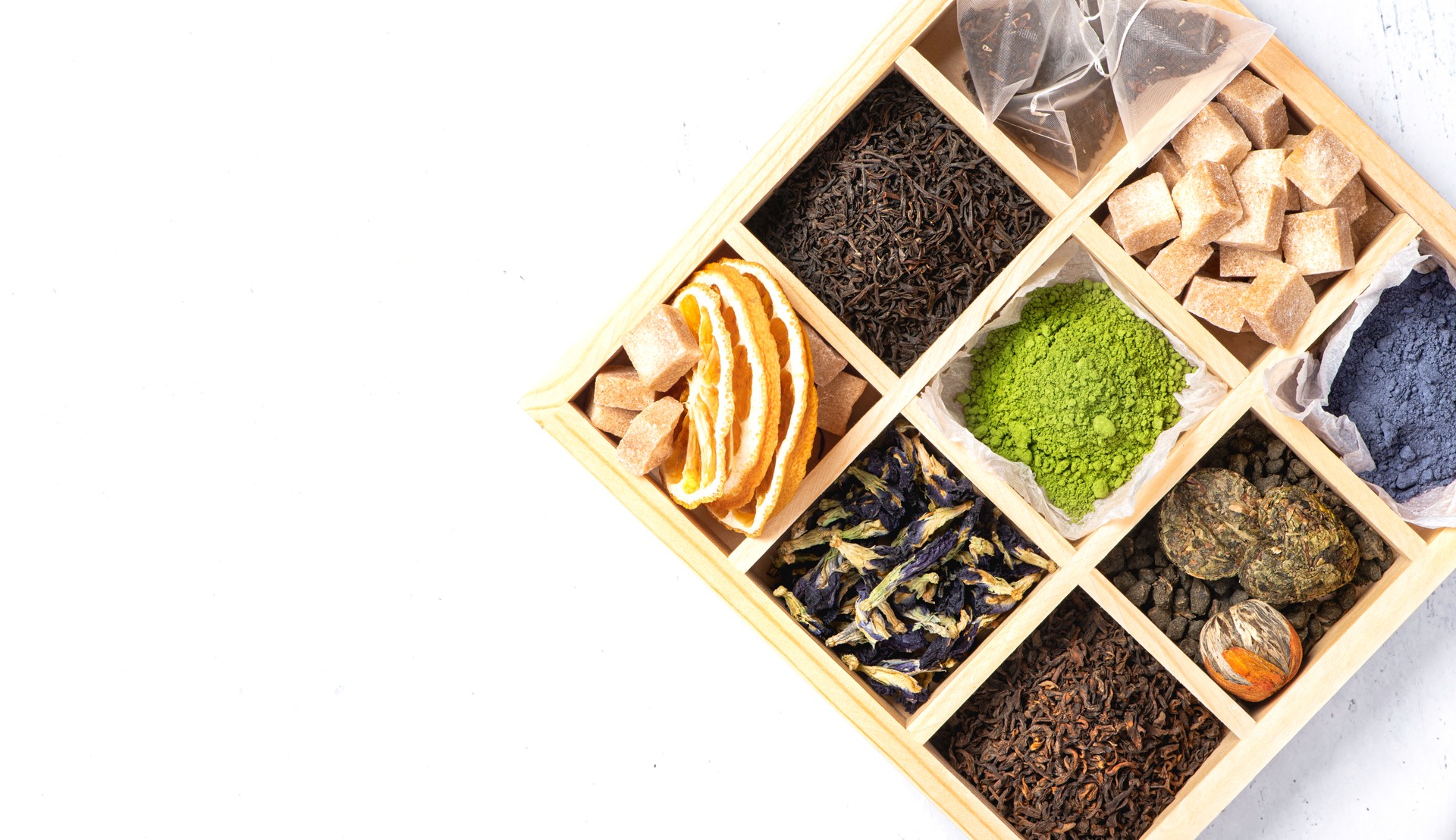 Different types of tea in a wooden box.